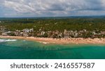 Aerial view of the Indian Ocean and the town of Hikkaduwa, Sri Lanka. Beach with golden sand and surfers in the water