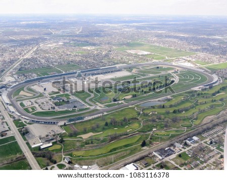 Aerial view of Indianapolis 500, an automobile race held annually at Indianapolis Motor Speedway in Speedway, Indiana through clouds. View from airplane. 