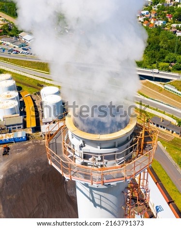 Aerial view to industrial area with coal power plant. Smoking chimney from factory. Air pollution and climate change theme. Heavy industry in European Union as a co2 emissions source. 