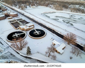 Aerial View Of Industrial Area Of Fort Collins, Colorado With A Waste Water Treatment Plant And A Frozen Lake With Waterfowl, Winter Scenery At Dusk