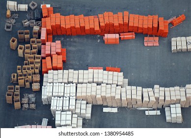 Aerial View Of Industrial Building Material, PVC Pipes And Plastic Material Stacked On A Construction Site