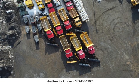 Aerial View Of An Industrial Courtyard With Snow Plow Lined Up.