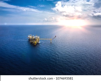 Aerial View Industrial Offshore Oil And Rig Drilling Platform In The Gulf With Blue Sky,Copy Space.