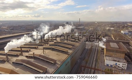 Aerial view of industrial steel plant. Aerial sleel factory. Flying over smoke steel plant pipes. Environmental pollution. Smoke.