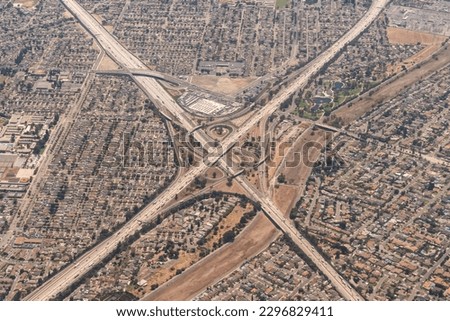 Aerial view of the interchange of the I-5 Santa Ana Freeway and the I-605 San Gabriel Freeway with the San Gabriel River and Wilderness Park in Santa Fe Springs