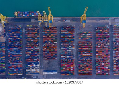 Aerial View To A Lot Of Intermodal Shipping Container Are In A Port. Cargo Transportation System On Ships. Graphic View Of Multi-colored Containers On Top. Equipment And Cranes