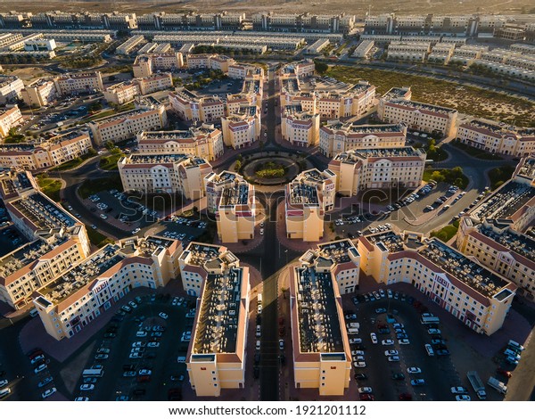 Aerial\
view of International City in Dubai, United Arab Emirates. Suburban\
country-themed architecture of residences, business, and tourist\
attractions outside of Dubai downtown in the\
UAE