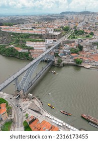 aerial view of an intersection between a bridge and a river within a city with squares, parks, monuments and attractions