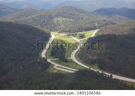 An aerial view of the intersection and bridge where highway 16 and highway 16a meet in South Dakota's Black Hills.