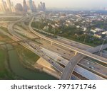 Aerial view Interstate 10, I-45 freeway with massive intersection, stack interchange, elevated road junction overpass in North Houston. Suburban residential houses and downtown skylines in background