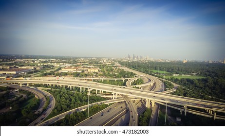 Aerial view interstate 10, Katy freeway and downtown with massive intersection, stack interchange, elevated road junction overpass at late afternoon from the west side of Houston, Texas, US. Vintage.
