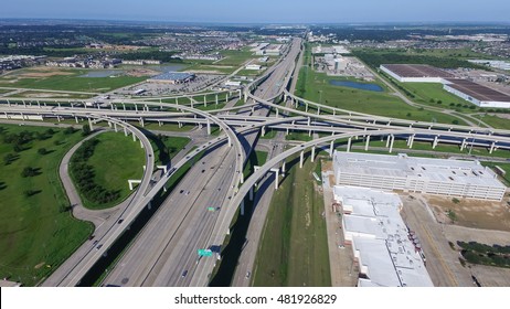 Aerial view Interstate 10 or Katy freeway with massive intersection, stack interchange, elevated road junction overpass in daytime with clear blue sky. Aerial metropolitan area of Katy, Texas, US.