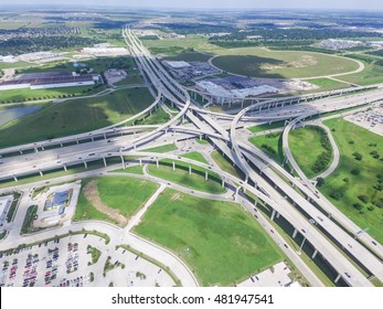 Aerial view Interstate 10 or Katy freeway with massive intersection, stack interchange, elevated road junction overpass in daytime with cloud blue sky. Aerial metropolitan area of Katy, Texas, US.