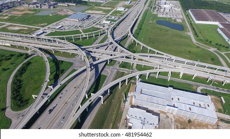 Aerial view Interstate 10 or Katy freeway with massive intersection, stack interchange, elevated road junction overpass in daytime. Nightly degree vertical view metropolitan area of Katy, Texas, US.