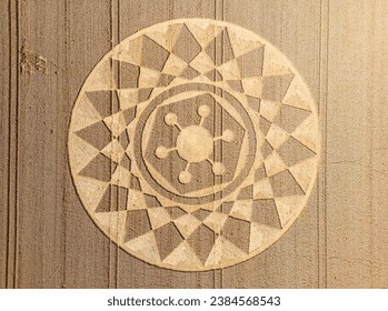 Aerial view of an intricate geometric crop circle formation in a wheat field in Wiltshire, England, UK - Powered by Shutterstock