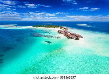 Aerial View Of A Island In The Maldives With Turquoise Waters