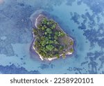 An aerial view of an island at  Papanui Inlet, in South Island, New Zealand