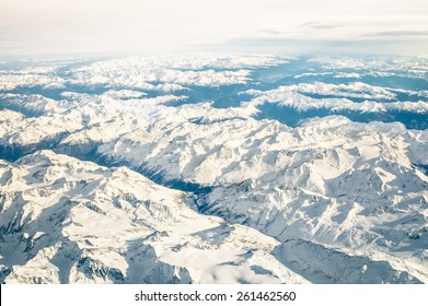 Aerial View Of Italian Alps With Snow And Misty Horizon - Travel Concept And Winter Vacation On White Snowy Mountains - Trip Wander To Exclusive Luxury Destinations