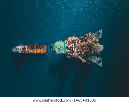 Aerial view of jack up rig with towing vessel during towing operation