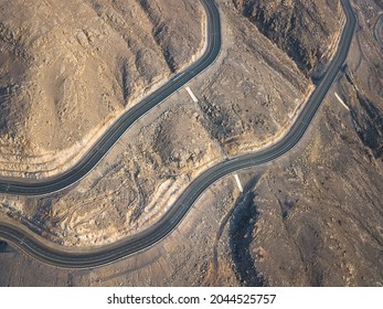 Aerial view of Jebel Jais mountain desert highway road surrounded by sandstones in Ras al Khaimah emirate of the United Arab Emirates - Powered by Shutterstock