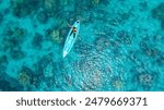 Aerial view of a kayak in the blue sea .Woman kayaking She does water sports activities.