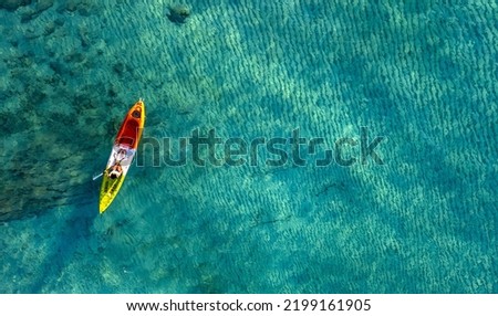 Aerial view of a kayak in the blue sea .Woman kayaking She does water sports activities. soft focus