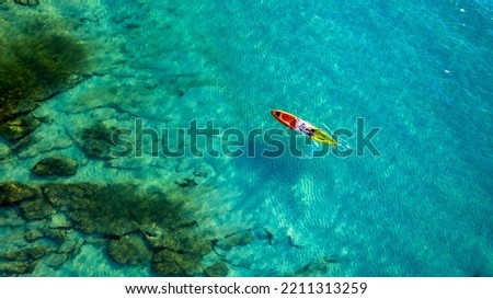 Aerial view of a kayak in the blue sea .Woman kayaking She does water sports activities.