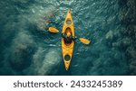 Aerial View of a Kayaker on Clear Waters, Top-down perspective of a kayaker in a yellow kayak navigating the crystalline blue waters
