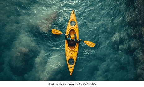 Aerial View of a Kayaker on Clear Waters, Top-down perspective of a kayaker in a yellow kayak navigating the crystalline blue waters