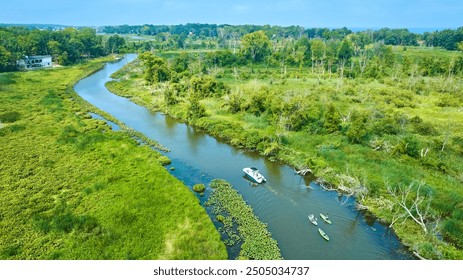 Aerial View of Kayaking and Boating on Serene River in Lush Landscape - Powered by Shutterstock