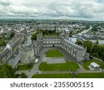 Aerial view of Kilkenny castle, Victorian remodeling of a medieval defensive structure, rolling parkland, terraced rose garden, woodlands, man-made lake by the Nore river