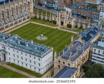 Aerial view of King's College Chapel in Cambridge, UK, showcasing Gothic architecture, manicured lawns, and adjacent university buildings with ornate facades. - Powered by Shutterstock