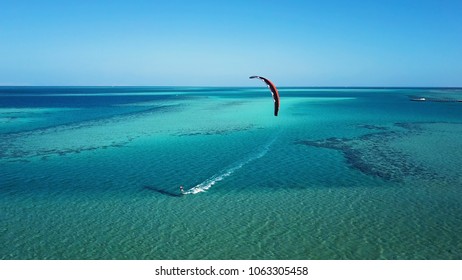 Aerial View. Kite Surfing On The Blue Sea In The Background Of Beautiful Clouds