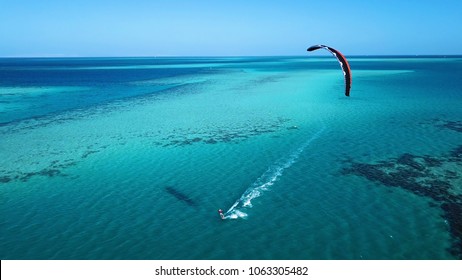 Aerial view. Kite surfing on the blue sea in the background of beautiful clouds
