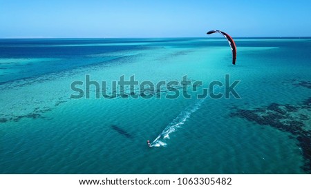 Aerial view. Kite surfing on the blue sea in the background of beautiful clouds