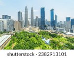 Aerial view of the KLCC Park and the Petronas Twin Towers in Kuala Lumpur, Malaysia. The urban park in Kuala Lumpur City Center is a popular tourist attraction of Asia. Awesome Kuala Lumpur skyline.