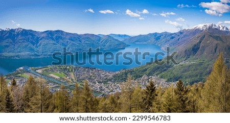 Aerial view of Lake Maggiore with two Brissago Islands and colordful towns of Locarno and Ascona. Monte Rosa massif at background. Switzerland.