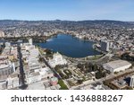 Aerial view of Lake Merritt Park and downtown buildings and streets in Oakland California.