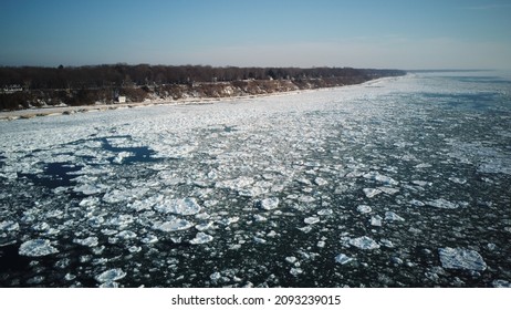 Aerial View of Lake Michigan Frozen Over in the Winter, Showing Shoreline and Ice in the Water