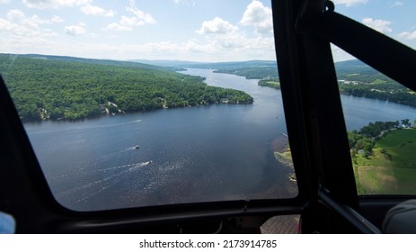 An Aerial View Of A Lake Through An Helicopter Door