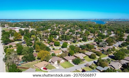 Aerial view lakeside neighborhood along Kimball Avenue near downtown Grapevine, Texas, America. Row of typical one story single family houses with large backyard and matured trees