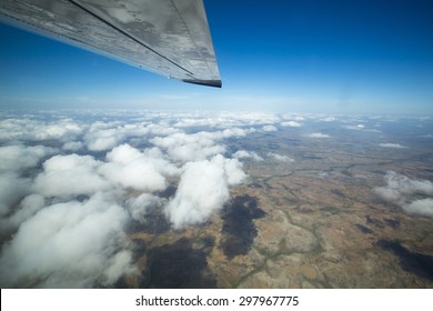 Aerial View Of The Land Over The Clouds And Blue Sky On The Way To Ciudad Bolivar By Small Plane. Venezuela