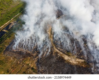 An Aerial View Of A Landfill Site On Fire