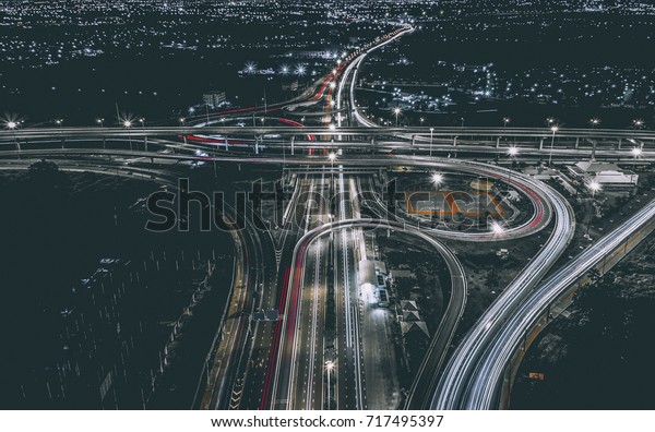 Aerial view of\
landscape perfect night road, top view at night traffic long\
exposure. color tone\
effect.