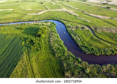 Aerial View Landscape Of Winding River In Green Field