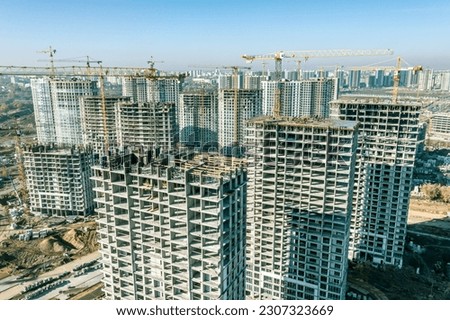 aerial view of a large construction site with multistory residential buildings under construction.