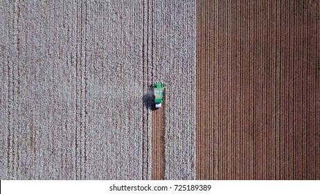Aerial view of a Large green Cotton picker working in a field.