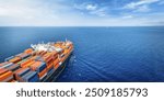 Aerial view of a large, industrial container cargo ship sailing over the ocean with copy space