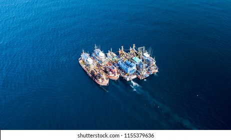 Aerial view of a large number of fishing trawlers operating together illegally in a marine reserve - Shutterstock ID 1155379636