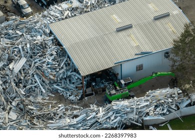 Aerial view of large pile of scrap aluminum metal from broken houses after hurricane Ian swept through Florida. Recycle of broken parts of mobile homes - Powered by Shutterstock